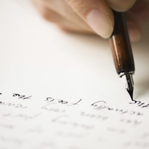 person writing a letter